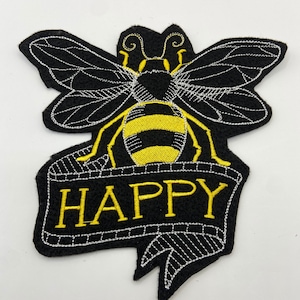 May include: Black embroidered patch with a yellow and black bee and a banner that says "HAPPY".