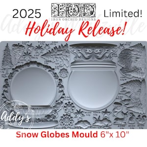 May include: A light gray silicone craft mould featuring two large circular snow globe designs, various evergreen trees, snowflakes, stars, and woodland animals. The text 2025 Iron Orchid Designs Holiday Release and Snow Globes Mould 6" x 10" is visible.