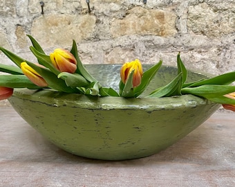 A large, hand-painted sustainable hardwood bowl