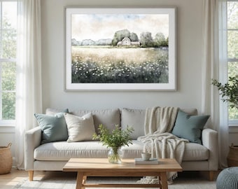 Könnte beinhalten: Ein gerahmter Aquarelldruck einer ländlichen Landschaft mit einem weißen Bauernhaus, Bäumen und einem Feld mit Wildblumen. Das Kunstwerk wird über einem beigen Sofa mit Kissen und einem Holztisch ausgestellt. Der Raum hat neutrale Töne und natürliches Licht.