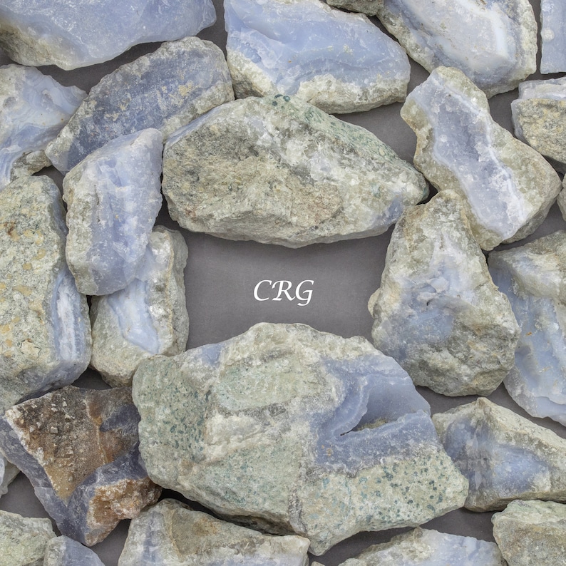 May include: A collection of blue and gray agate stones with the letters "CRG" written in white on a gray background.