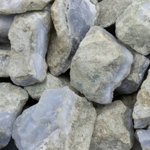 May include: A pile of blue and gray agate stones. The stones are rough and have a natural, unpolished look.