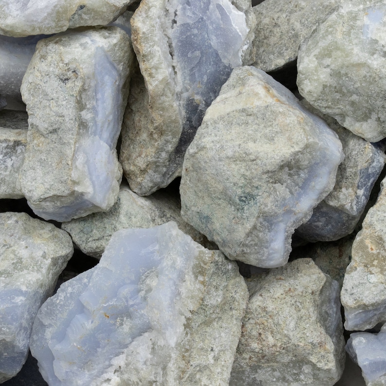May include: A pile of blue and gray agate stones. The stones are rough and have a natural, unpolished look.