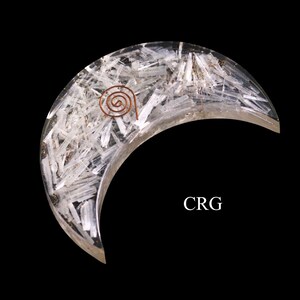 May include: A clear crystal crescent moon with a copper wire spiral on top. The moon is made of many small, clear crystals.