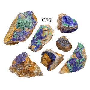 May include: A collection of seven raw mineral specimens featuring vibrant blue azurite and green malachite deposits embedded in tan and brown rock matrix. The text CRG is printed in black in the upper center of the image among the stones.
