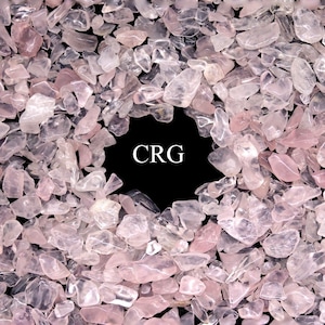 May include: A close-up image of a large quantity of small, light pink, translucent rose quartz chips. The chips are arranged in a circle around a black background with the letters "CRG" in white.