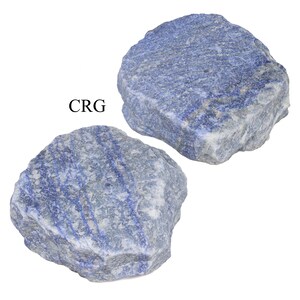 May include: Two blue and white, rough-hewn, natural stone slabs. The stone has a striated pattern. The text "CRG" is visible in the image.