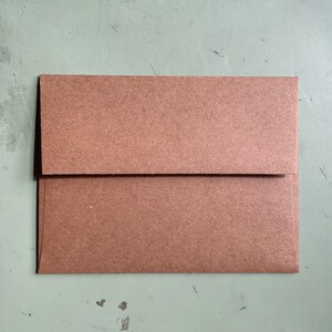 May include: A brown paper envelope with a flap.