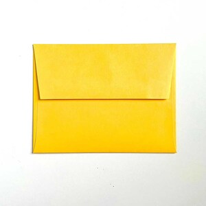 May include: A bright yellow envelope with a flap.