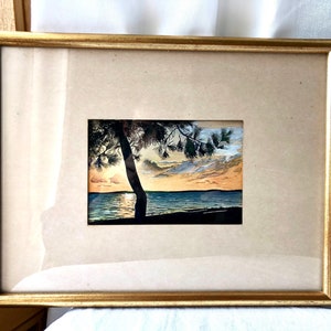 May include: Framed watercolour painting of a sunset over a lake with a silhouetted tree in the foreground.
