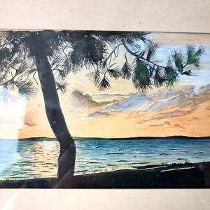 May include: A watercolour painting depicting a sunset over a lake, with a silhouette of a pine tree in the foreground. The sky is a blend of orange, pink, and blue, with wispy clouds. The water is a deep blue, reflecting the sunset.