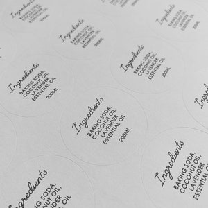May include: White round labels with black text that reads "Ingredients: Baking Soda, Coconut Oil, Lavender Essential Oil, 200ml".