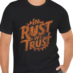 May include: Black t-shirt with an orange graphic that says "In Rust We Trust" in a distressed font.