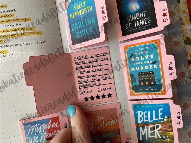 May include: A close-up of a pink book tracker with several book covers visible. The book tracker has a five-star rating system and space to write the book title, author, start date, finish date, pages, format, genre, release date, publisher, and review. The book covers are for "Darling Girls" by Sally Hepworth, "How to Solve Your Own Murder" by Kristen Brown, "Belle Mer" by  Simone St. James, and "The Heirloom" by