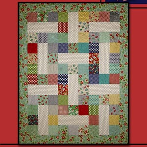 May include: A patchwork quilt with the text "LATIN LADY" at the top. The quilt features a variety of patterned squares in red, white, blue, green, and yellow. A red rose is in the upper right corner.
