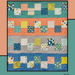 May include: A colorful quilt with the word "Candies" at the top. The quilt features rows of patterned squares in various colors, including teal, peach, yellow, and blue. The design is by Heidi Cook for Villa Rosa Designs.