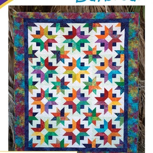May include: A colorful quilt pattern titled "Daybreak" by Cozy Quilt Designs. The quilt features a repeating star pattern in vibrant colors like orange, green, blue, and purple. The design is by Georgette Dell'Orco. The pattern is for 2 1/2" strips and includes baby, lap, throw, twin, queen, and king sizes.