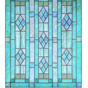 May include: A quilt pattern called "Abigail's Window" with a stained glass design in shades of blue and green. The pattern is designed by Minay Sirois and is available from Black Cat Creations.