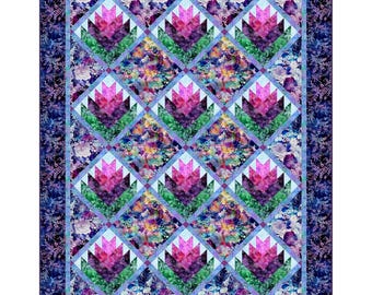 May include: A quilt with a floral pattern in shades of pink, purple, green, and blue. The quilt is made up of squares with a diamond pattern in the center. The quilt is surrounded by a border of a floral pattern in shades of blue and purple.