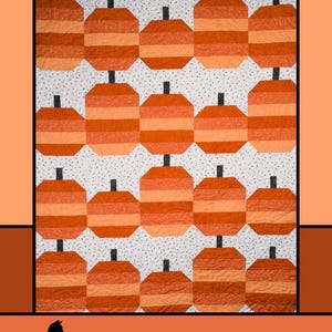 May include: A quilted wall hanging with a pumpkin design. The pumpkins are orange and light orange with black stems, set against a white background with small black and blue dots. The text "Pumpkin Parade" and "Melissa Milligan for Villa Rosa Designs" are displayed.
