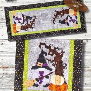 May include: A Home With Witch Gnome table runner sewing pattern, 16" x 38", featuring a gnome in a black witch hat holding a broomstick next to a brown tree and orange pumpkins on a gray background with a black border with stars and moons.