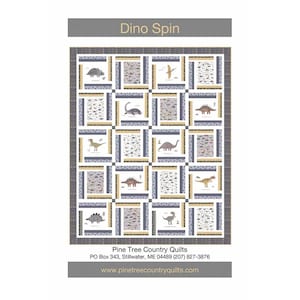 May include: A Dino Spin quilt featuring a grid of dinosaur illustrations in various colors. The quilt has a gray border and a repeating pattern of squares with dinosaur images. The text "Dino Spin" is at the top, and the Pine Tree Country Quilts information is at the bottom.