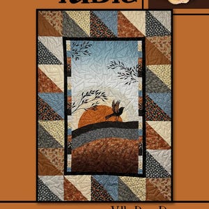 May include: A quilt pattern called "Fable" by Villa Rosa Designs. The pattern features a sunset with a bird flying over a field of grass. The quilt is made up of a variety of fabrics in shades of brown, blue, and cream.