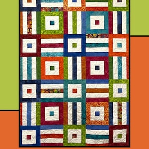 May include: A colorful quilt with a patchwork design. The quilt features squares and rectangles in various colors, including blue, green, orange, and white. The text "Chutes & Ladders" is at the top, and the designer's name is at the bottom.