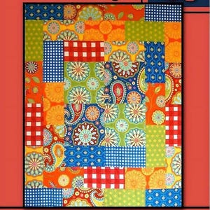May include: A vibrant patchwork quilt with floral, paisley, and gingham patterns in orange, blue, green, and red. The text "On Stage" is at the top, and "Villa Rosa Designs" is at the bottom. A rose is in the upper right corner.