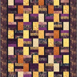 May include: A rectangular quilt featuring a grid of alternating vertical and horizontal fabric rectangles in shades of purple, gold, and orange. The fabric patterns include solid-colored textures and intricate paisley prints with a dark border.