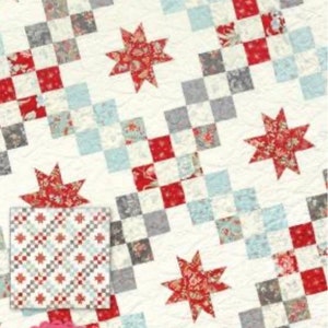 May include: A quilt pattern titled "Castle Courtyard" featuring a repeating pattern of red, gray, and blue squares and star-shaped accents. The design includes a smaller square with a similar pattern and the designer's name.