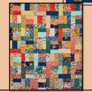 May include: A quilt pattern called "Vienna" by Villa Rosa Designs. The quilt is made up of colorful squares with floral patterns in shades of red, blue, yellow, green, and pink. The quilt is surrounded by a border of green leaves and red flowers.