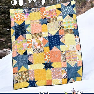May include: A quilt pattern called "Stargazer" by Running Doe Quilts for Villa Rosa Designs. The quilt is made of yellow, orange, and blue fabric with a star pattern.