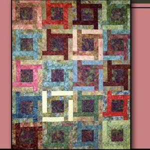 May include: A colorful quilt with a geometric pattern, featuring squares and rectangles in shades of blue, green, red, and pink. The word "VOYAGER" is at the top, and "Villa Rosa Designs" is at the bottom. A rose is in the upper right corner.