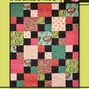 May include: A quilt pattern called "Kalinda" by Villa Rosa Designs. The quilt is made up of black, white, pink, green, and yellow squares. The quilt is surrounded by a border of green, pink, and yellow flowers.