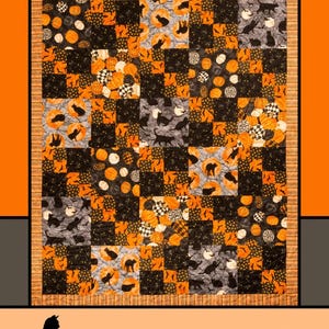 May include: A quilt pattern featuring a black cat, pumpkins, and leaves in orange, black, and white. The quilt is titled "Kit & Caboodle" and is designed by Melissa Milligan for Villa Rosa Designs.