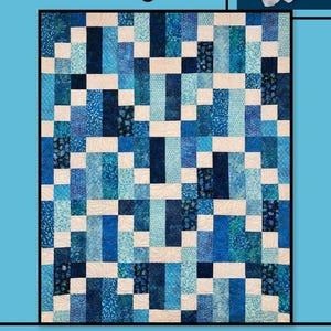 May include: A quilt with a patchwork design in shades of blue and white. The quilt features a variety of patterned fabrics arranged in a rectangular pattern. The words "Morning Tea" are at the top, and "Villa Rosa Designs" is at the bottom.
