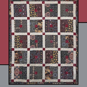 May include: A quilt with the text "Fruit Cake" at the top. The quilt features a grid pattern with various patterned squares in shades of gray, red, and gold, separated by white and red borders. The quilt is designed by Heidi Cook for Villa Rosa Designs.