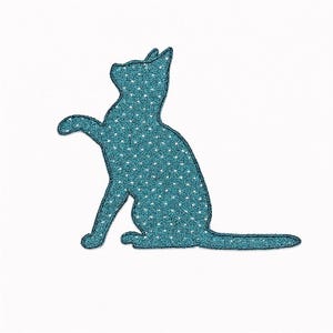 May include: A teal cat silhouette with white polka dots, sitting with one paw raised. The cat has a dark blue outline and is set against a white background. The design is likely for a patch or sticker.