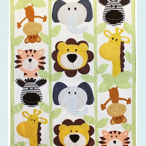 May include: A colorful applique quilt pattern featuring jungle animals like a lion, tiger, giraffe, zebra, and monkey. The pattern is titled "Jungle Buddies Applique Quilt Pattern" and is designed by Jennifer Heynen Creative Co.