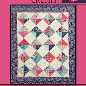 May include: A quilt pattern called "Raspberry Cream" by Villa Rosa Designs. The quilt features a white background with a geometric pattern of pink, blue, and gray triangles. The quilt is surrounded by a blue and pink floral border.