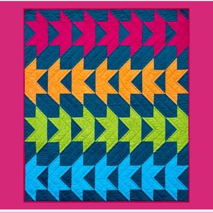 May include: A colorful quilt with a star pattern in shades of pink, orange, green, and blue. The quilt has a quilted texture and is set against a pink background. The word "Viroqua" is at the top.