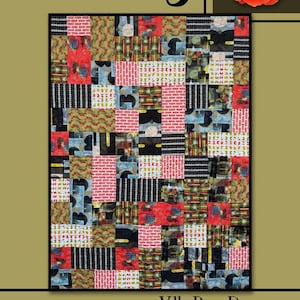 May include: A patchwork quilt titled "Felicity" with a variety of patterned squares in red, black, blue, and green. The quilt is framed in black, with a rose in the upper right corner. The text "Villa Rosa Designs" is at the bottom.