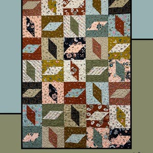 May include: A quilt pattern called "Jackknife" designed by Molly Cook for Villa Rosa Designs. The quilt features a geometric pattern of squares and rectangles in various shades of brown, green, blue, and pink. The quilt is made with fabric featuring floral and geometric prints.