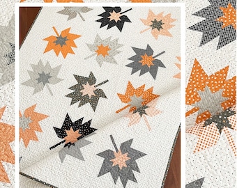 May include: A quilt with a leaf pattern in shades of orange, gray, and black on a white background. The quilt features the text "Forest Floor" and the website address www.thepatternbasket.com.