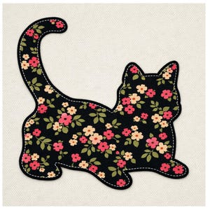 Peut inclure: Applique en forme de chat noir avec un motif floral de fleurs roses et pêche et de feuilles vertes. L'applique a une bordure cousue blanche et est posée sur un fond crème.