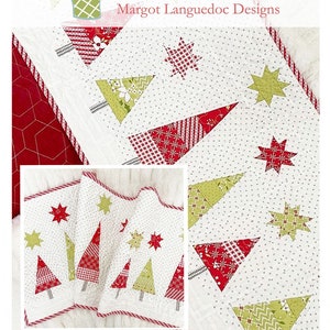 May include: A white table runner with a Christmas tree and star pattern. The trees are red and green, and the stars are green and red. The runner has a red border and the text "Snowy Pines Table Runner".