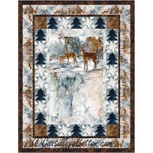 May include: A quilted wall hanging featuring a winter forest scene with deer. The central image shows deer in a snowy landscape, framed by borders of trees, stars, and a brown patterned edge. The text "CastillejaCotton.com" is at the bottom.