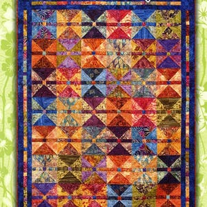 May include: A quilt pattern called "Fat Quarter Stir Fry" designed by Judy Reynolds. The quilt features a colorful patchwork design with a blue border.