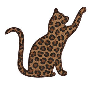 May include: A leopard print cat silhouette with a raised paw. The cat is brown with dark brown spots and a stitched outline. The design is on a white background.
